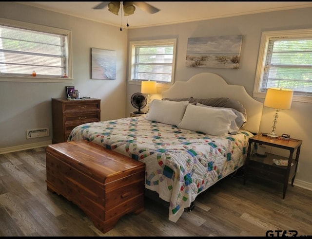 bedroom featuring ornamental molding, dark wood-type flooring, and ceiling fan