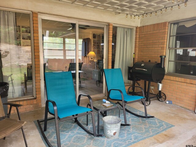 view of patio with ceiling fan and grilling area