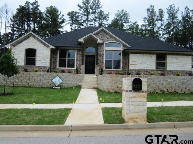 8016 Crooked Trl, Tyler, TX 75703 - view of front facade featuring a front yard and brick siding