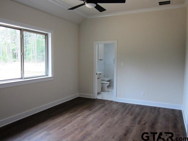 spare room featuring ornamental molding, lofted ceiling, dark hardwood / wood-style floors, and ceiling fan