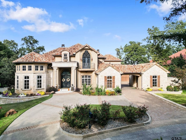 mediterranean / spanish-style home featuring a balcony