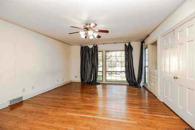 unfurnished bedroom featuring ceiling fan, light hardwood / wood-style floors, and ornamental molding