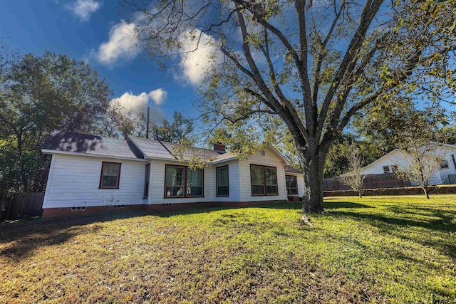 rear view of property with a lawn