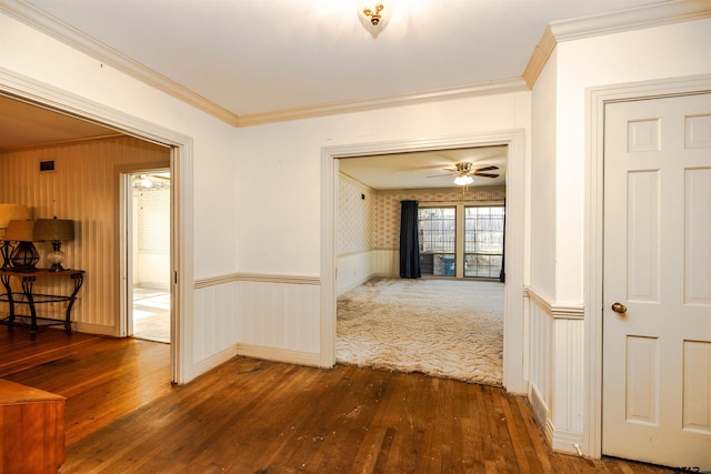 hallway with hardwood / wood-style flooring and ornamental molding