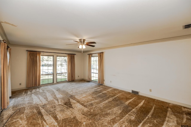 carpeted spare room featuring ceiling fan and crown molding