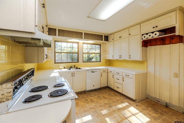 kitchen featuring decorative backsplash, white appliances, and sink