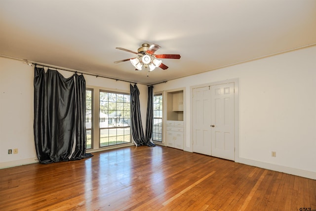 spare room with hardwood / wood-style flooring and ceiling fan