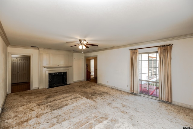 unfurnished living room featuring ceiling fan, crown molding, a high end fireplace, and light colored carpet