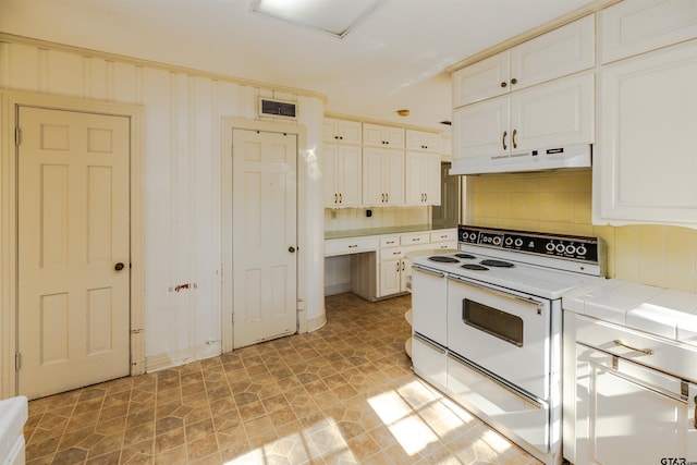 kitchen featuring tile countertops, white range with electric stovetop, and backsplash