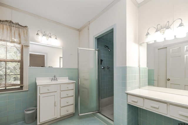 bathroom featuring a shower with shower door, tile walls, and ornamental molding