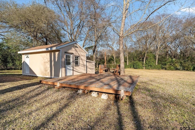 view of yard with a shed, an outdoor structure, and a wooden deck