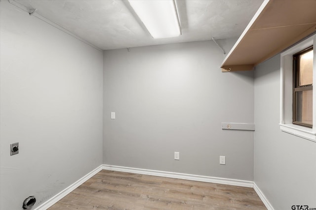 washroom featuring laundry area, electric dryer hookup, baseboards, and wood finished floors