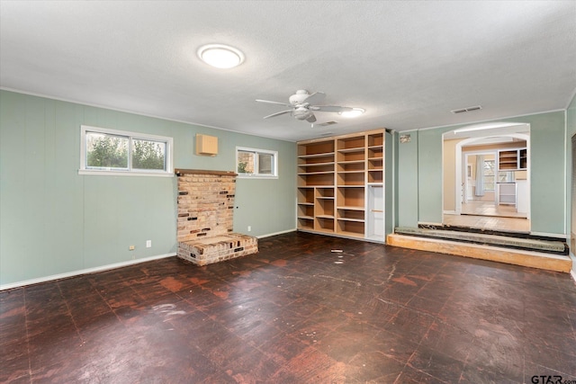 interior space featuring ceiling fan, a textured ceiling, visible vents, baseboards, and tile patterned floors