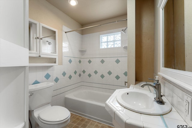 full bathroom featuring toilet, a sink, tile walls, shower / bathing tub combination, and backsplash