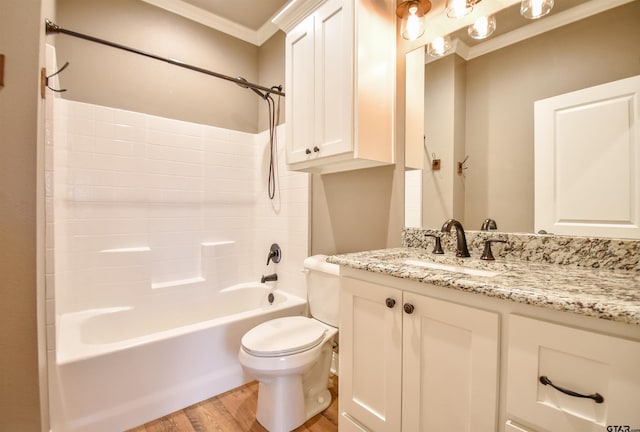 full bath featuring vanity, ornamental molding,  shower combination, toilet, and wood finished floors
