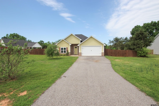 single story home featuring aphalt driveway, fence, an attached garage, and a front yard