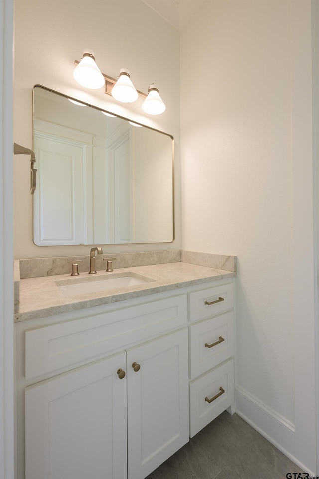 bathroom with baseboards and vanity