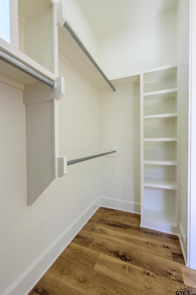 walk in closet featuring wood finished floors