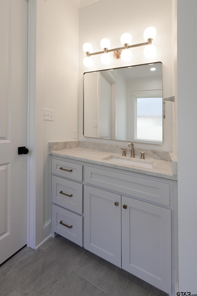 bathroom featuring tile patterned flooring and vanity