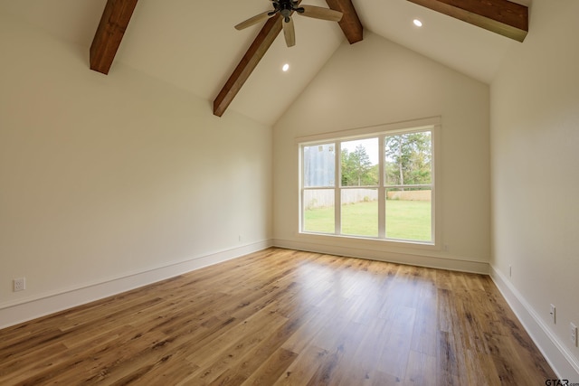 spare room with high vaulted ceiling, wood finished floors, beam ceiling, and baseboards