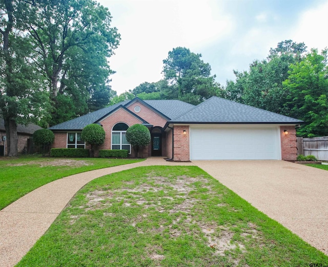 single story home with brick siding, a garage, a front yard, and concrete driveway