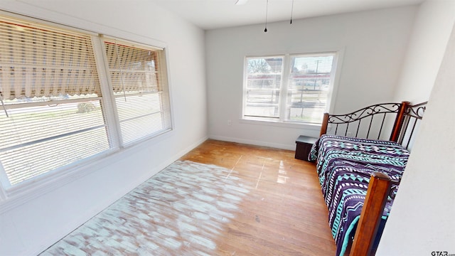 bedroom featuring light wood-type flooring and baseboards