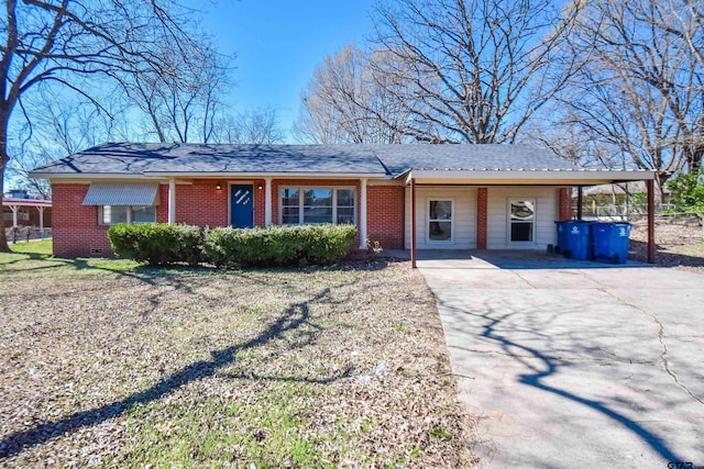 ranch-style home featuring roof with shingles, brick siding, and crawl space