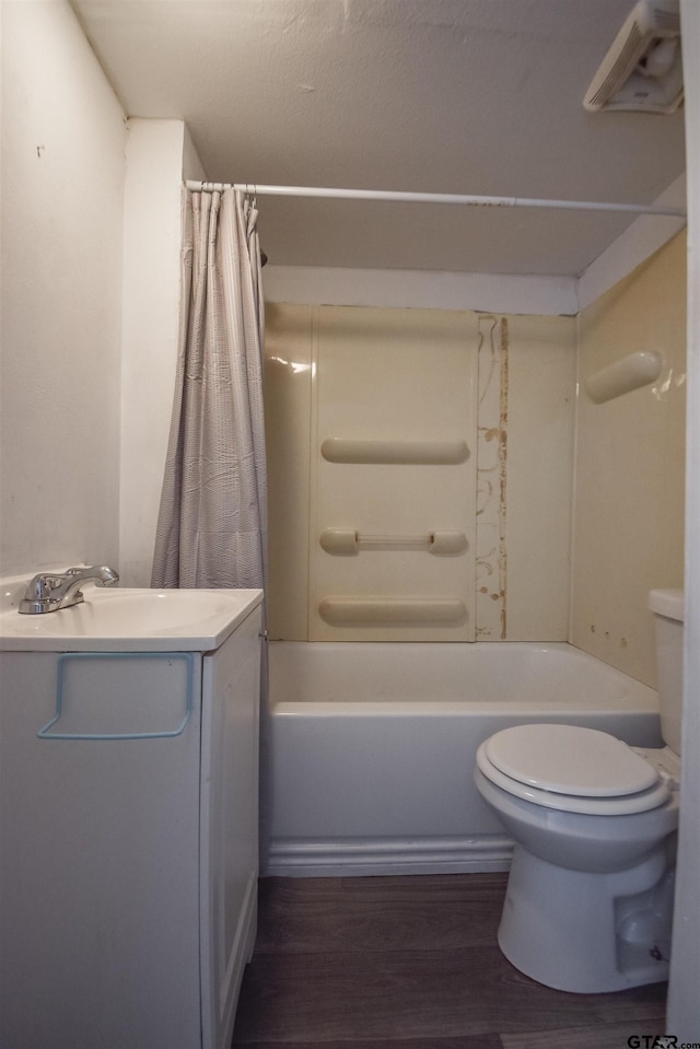 full bathroom with toilet, shower / bathtub combination with curtain, wood finished floors, and vanity