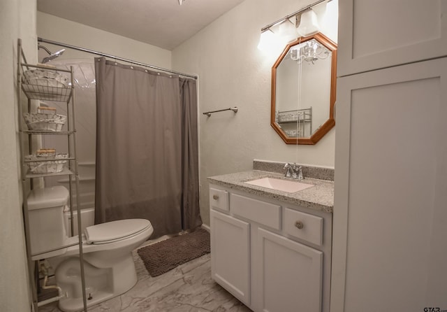 bathroom with marble finish floor, shower / tub combo with curtain, vanity, and toilet