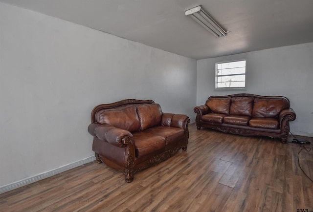 sitting room featuring baseboards and wood finished floors