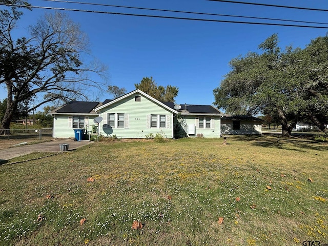 rear view of property with a yard