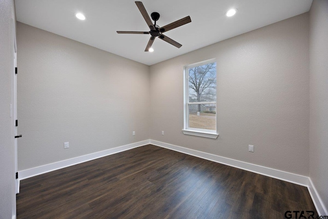 spare room featuring dark hardwood / wood-style floors and ceiling fan