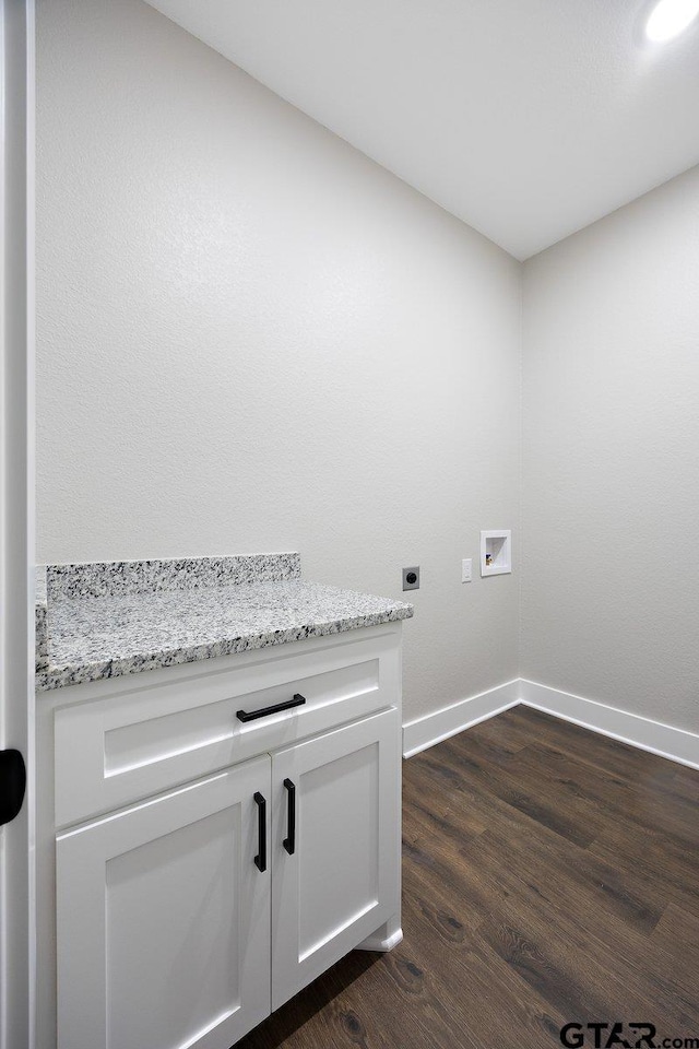 clothes washing area with washer hookup, cabinets, dark wood-type flooring, and hookup for an electric dryer