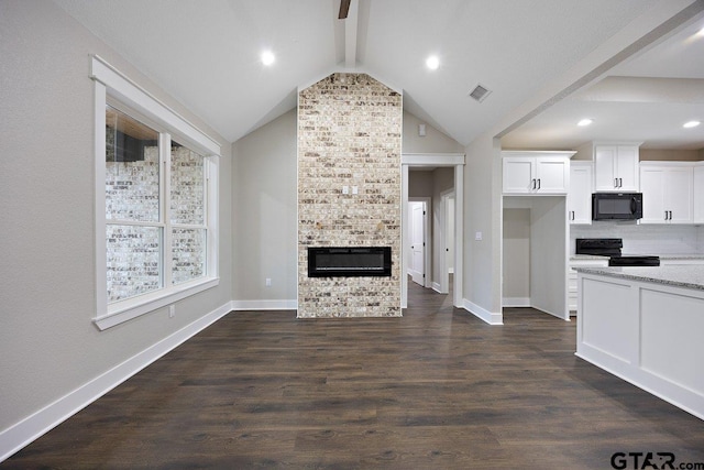 kitchen with dark wood-type flooring, vaulted ceiling with beams, white cabinetry, light stone countertops, and black appliances