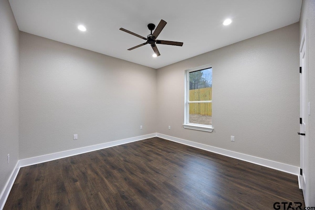 spare room featuring dark hardwood / wood-style floors and ceiling fan