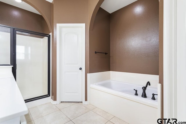 bathroom featuring tile patterned flooring and independent shower and bath