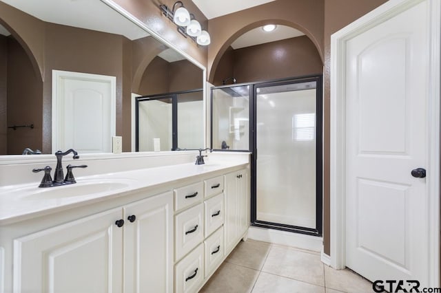 bathroom with tile patterned floors, vanity, and a shower with shower door