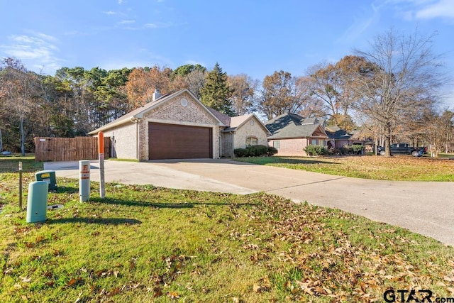 single story home with a front yard and a garage