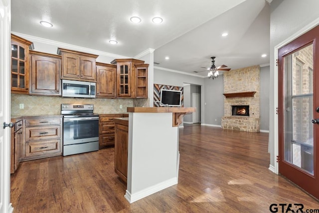 kitchen with electric range, decorative backsplash, ornamental molding, and a fireplace