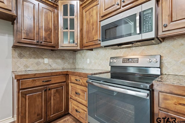 kitchen featuring backsplash and stainless steel appliances