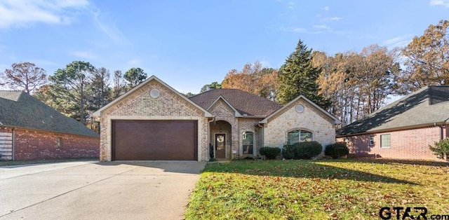 view of front of property with a garage and a front lawn