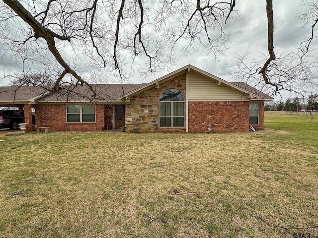 exterior space with a front yard and brick siding