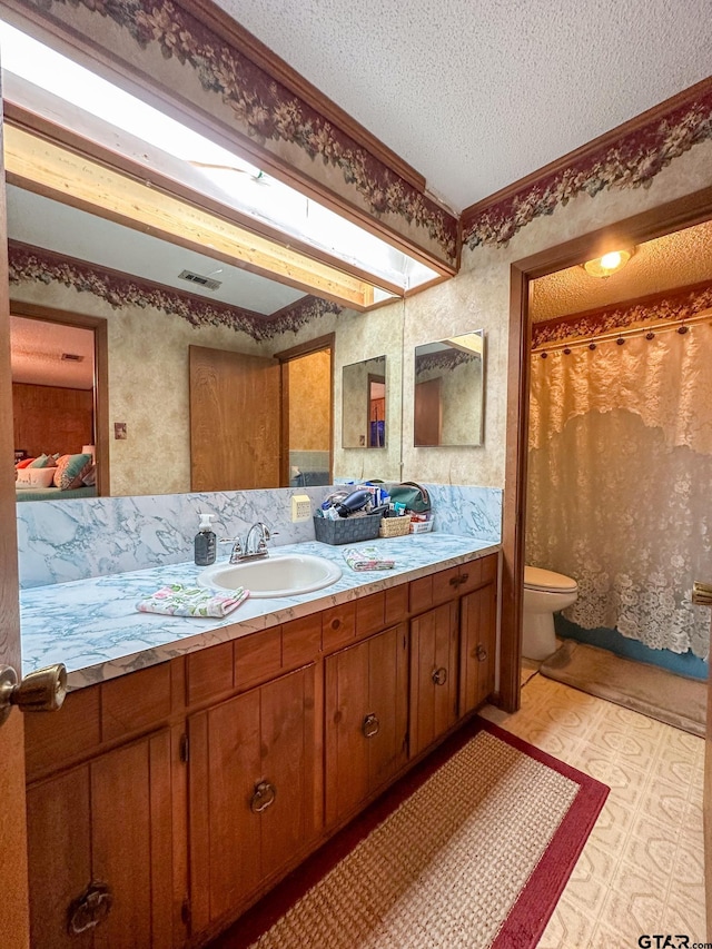 full bath with vanity, visible vents, a textured ceiling, tile patterned floors, and toilet