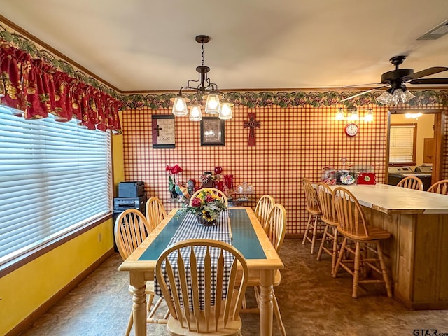 dining space featuring visible vents, ceiling fan with notable chandelier, and baseboards