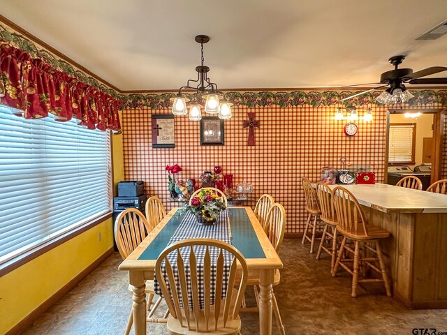 dining space featuring visible vents, ceiling fan with notable chandelier, and baseboards