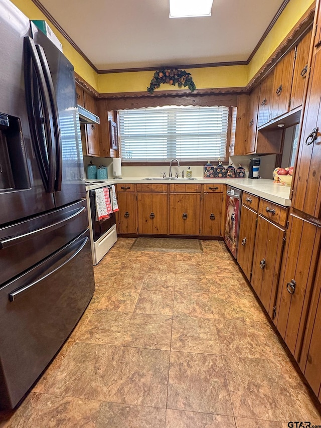 kitchen with range with electric cooktop, light countertops, black fridge with ice dispenser, washer / clothes dryer, and a sink