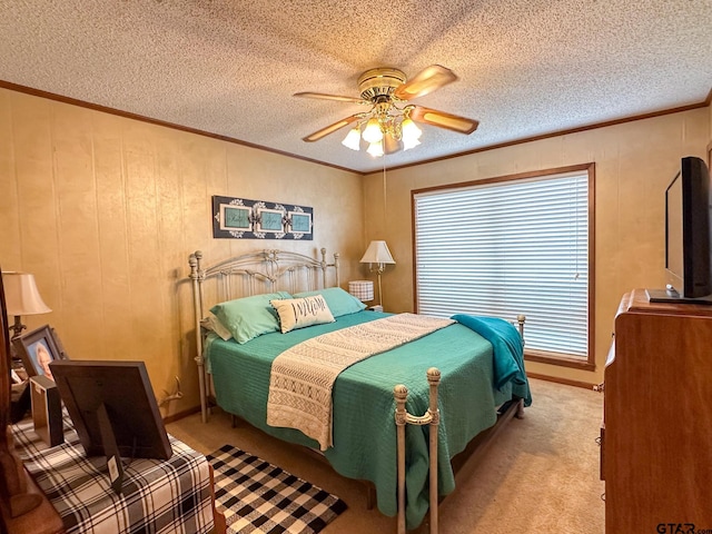 bedroom featuring a textured ceiling, ceiling fan, light colored carpet, and ornamental molding