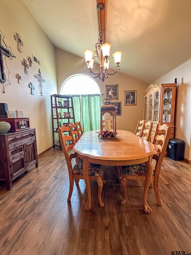 dining space featuring lofted ceiling, wood finished floors, baseboards, and a chandelier