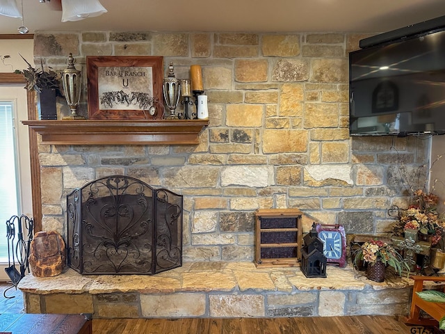 interior details featuring wood finished floors and a fireplace