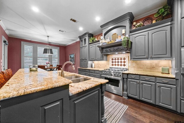 7736 Cross Rd, Tyler, TX 75703 - kitchen featuring stainless steel range, ornamental molding, gray cabinetry, a kitchen island with sink, and dark wood-type flooring